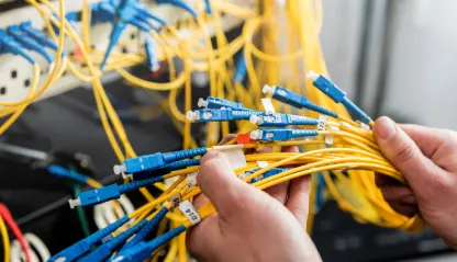 network-engineer-working-server-room-connecting-network-cables-switches-e1760626199512
